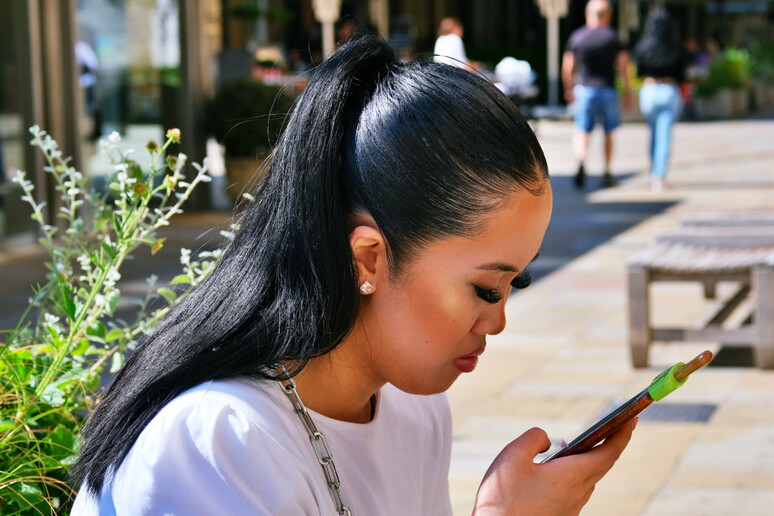 Young man on smartphone - ANSA